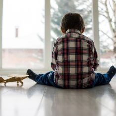 Sad kid sitting on floor